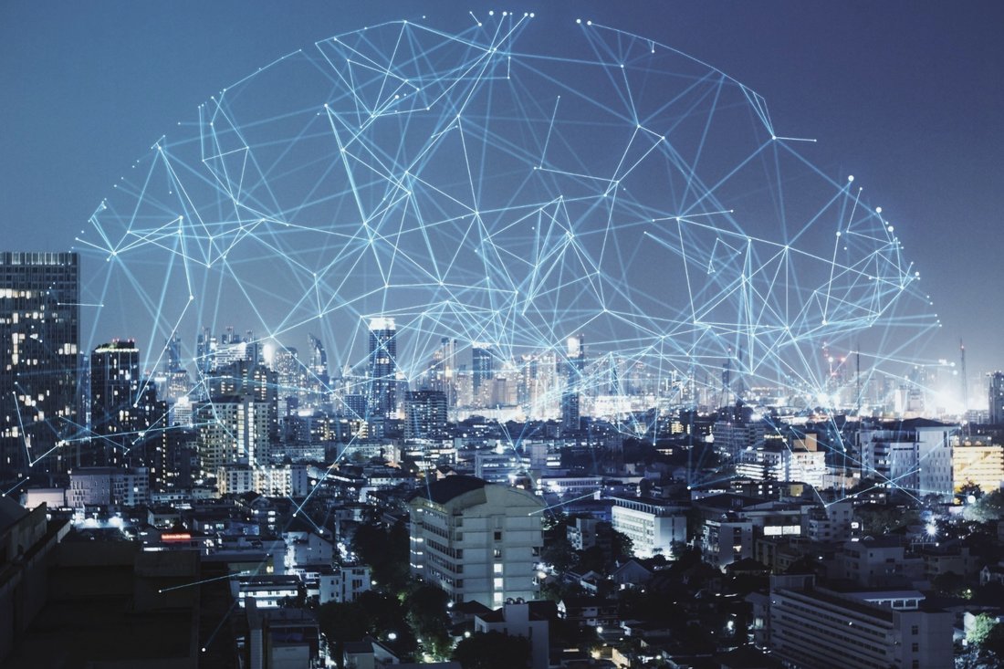 A night skyline overlaid with a luminous data-network sphere